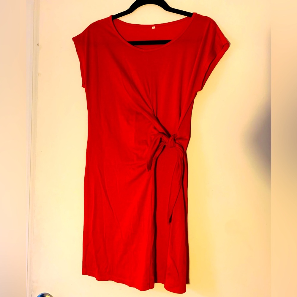 Red summer dress with waist clinching self tie knot on left side.